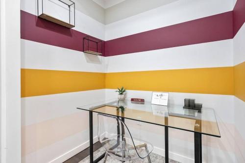 a glass table in a room with colorful walls at SWJ 2nd - Times SQ, Brooklyn Bridge, LGA in 15 min in New York