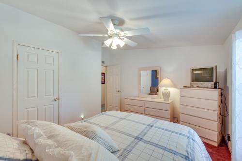 a bedroom with a bed and a ceiling fan at Lovely Lake Hartwell Retreat with Dock and Grill! in Hartwell