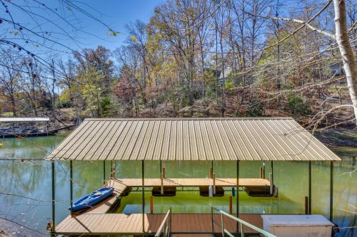 a house on the water with a roof at Lovely Lake Hartwell Retreat with Dock and Grill! in Hartwell