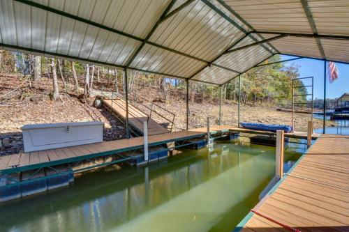 a house with a pool of water with a dock at Lovely Lake Hartwell Retreat with Dock and Grill! in Hartwell