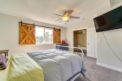 a bedroom with a bed and a flat screen tv at Charming Nampa Home with Backyard and Grill! in Nampa