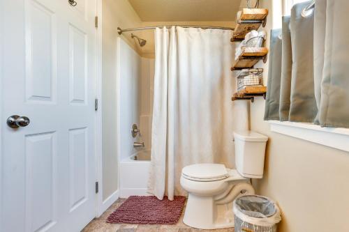 a bathroom with a toilet and a shower at Charming Nampa Home with Backyard and Grill! in Nampa