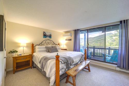 a bedroom with a bed and a large window at Cozy Sugar Mtn Condo with AandC - Walk to Ski and Golf! in Sugar Mountain