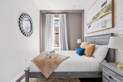 a bedroom with a bed with pillows and a window at SWJ 3rd - Sleeps 7,Close to LGA,Times Sq in 25 min in New York