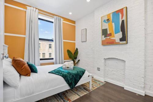 a bedroom with a bed and a fireplace at SWJ 3rd - Sleeps 7,Close to LGA,Times Sq in 25 min in New York