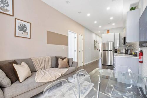 a living room with a couch and a kitchen at SWJ 3rd - Sleeps 7,Close to LGA,Times Sq in 25 min in New York