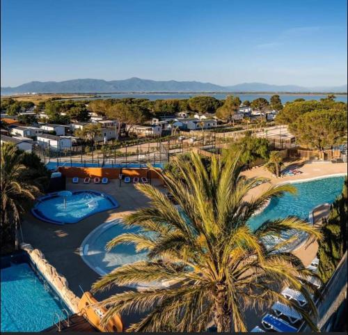 an aerial view of a resort with a pool and a beach at Camping Mar Estang in Canet-en-Roussillon