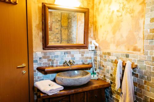a bathroom with a sink and a mirror at Apolithomeno Dasos Holiday Villas near Alexandroupolis in Lefkimmi