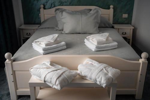 a bed with two towels sitting on top of it at Pensiunea Alessia Soveja in Soveja