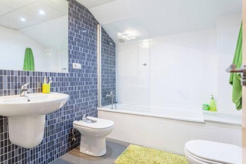 a bathroom with a sink and a toilet and a shower at Confortable Beach Appartment with Views to the Sea in Puzol
