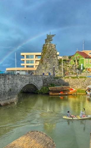 a group of people in kayaks on a river with a bridge at Green House in Virpazar