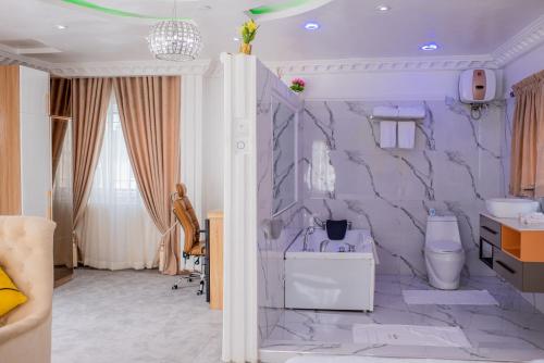 baño con pared morada y lavabo en MONDEESTARS LUXURY HOME, en Ibadán
