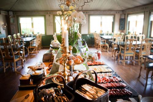 a long table with food on it in a restaurant at Åkerblads Hotell Gästgiveri Spa in Tällberg