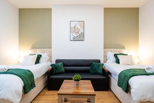 - un salon avec deux lits et un canapé dans l'établissement Innovation House, à Burnley