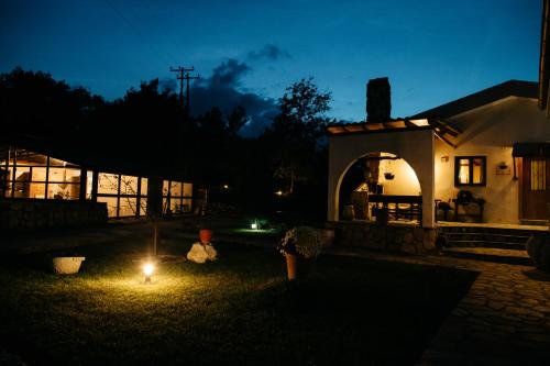 a house with a lit up yard at night at Apolithomeno Dasos Holiday Villas near Alexandroupolis in Lefkimmi