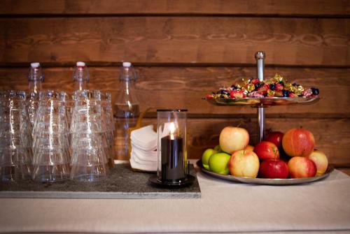 a table with a candle and a plate of apples at Åkerblads Hotell Gästgiveri Spa in Tällberg