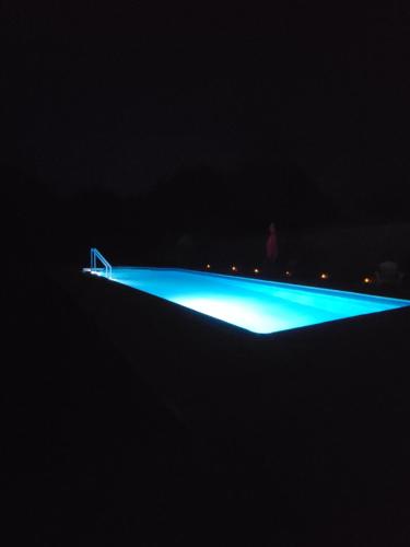 a beam of blue light in the dark at Les hauts Brianço in Solignac