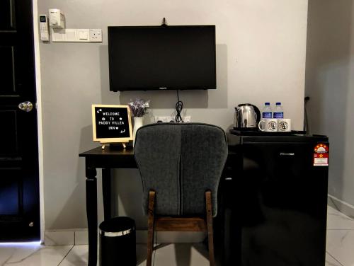 a desk with a computer and a chair in a room at Paddy Villea Inn SPT Penang in Permatang Pauh