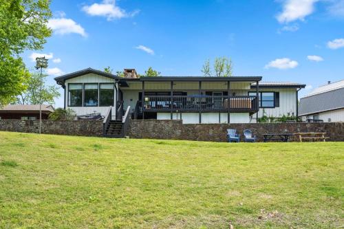 a large house with a patio and a yard at Red Bud Cove Lakefront Farm House on Table Rock Lake in Hollister
