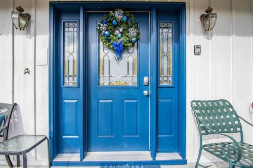 a blue front door with a wreath on it at Red Bud Cove Lakefront Farm House on Table Rock Lake in Hollister