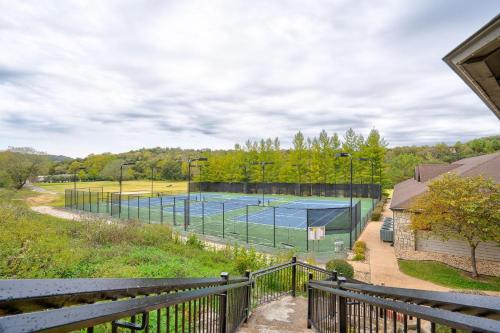 a tennis court in a field with a fence at Local Hero Lodge in Reeds Spring