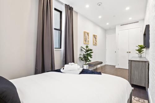 a bedroom with a large white bed and a window at SWJ 1st - Near Most Attractions Walk to Train Times Sq near in New York