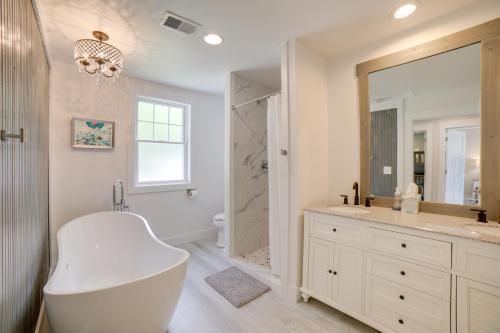 a bathroom with a large white tub and a shower at Cozy Pierson Paradise Lake Retreat with Fire Pit! in Howard City