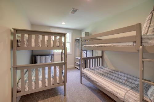 a bedroom with two bunk beds and a bunk room with a bunk bed at Cozy Pierson Paradise Lake Retreat with Fire Pit! in Howard City