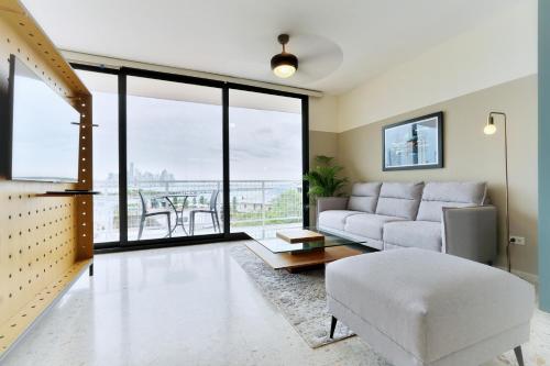 a living room with a couch and a table at La Moderna by Wynwood House in Panama City