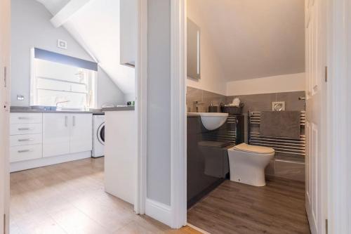 a white bathroom with a sink and a toilet at Castle Garden View in Rochester