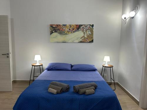 a bedroom with a blue bed with two pillows on it at casa vacanze Iside in Termini Imerese