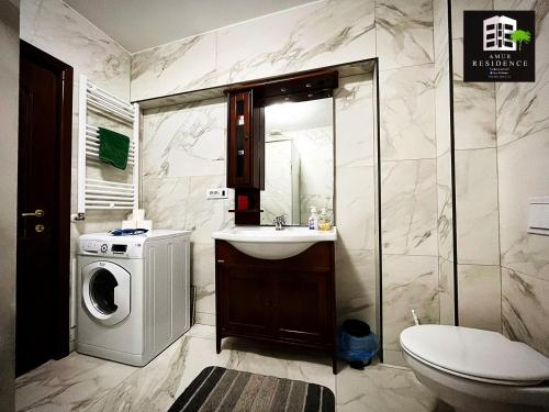 a bathroom with a washing machine and a sink at AmurResidence privat-Sauna City Center FamilyConcept in Iaşi