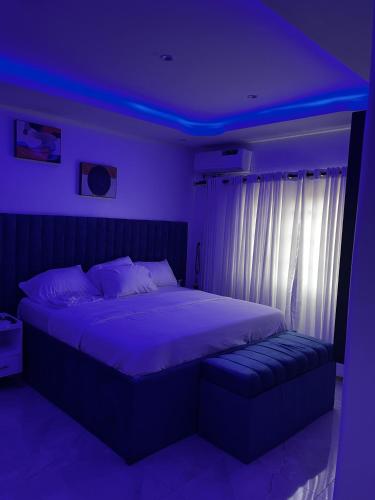 a bedroom with a bed with a purple lighting at Seaview Palace in Lekki