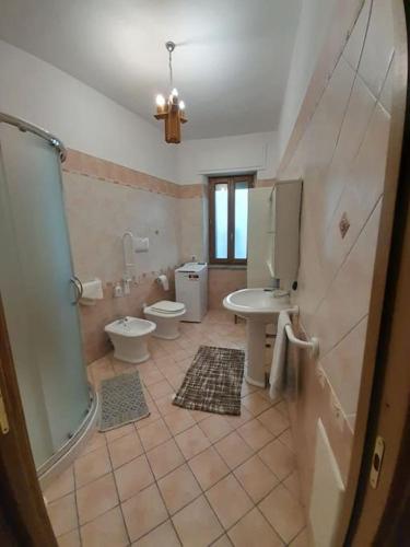 a bathroom with two toilets and a sink and a shower at appartamento in casa Lai in Desulo