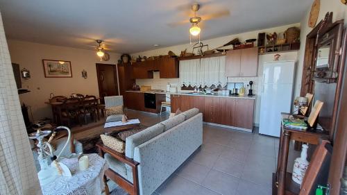 a large kitchen with a couch and a refrigerator at Mountain view Ioannis Ylation Saranti in Nicosia