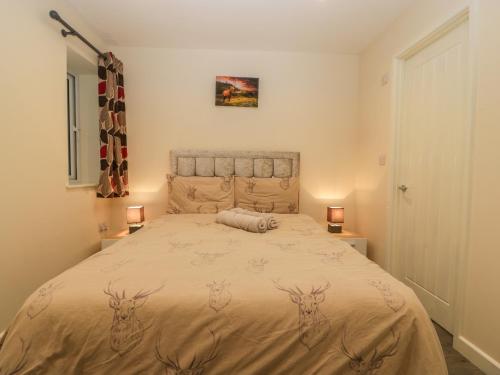 a bedroom with a bed with deer heads on it at Deers Leap in Lydney