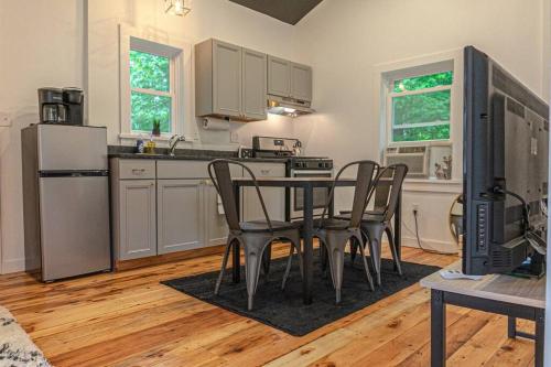 a kitchen with a table and chairs in a room at Double The Fun II Two Houses and fire pit in shared yard in Kingston
