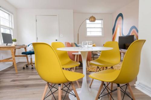 a meeting room with a table and yellow chairs at Double The Fun II Two Houses and fire pit in shared yard in Kingston