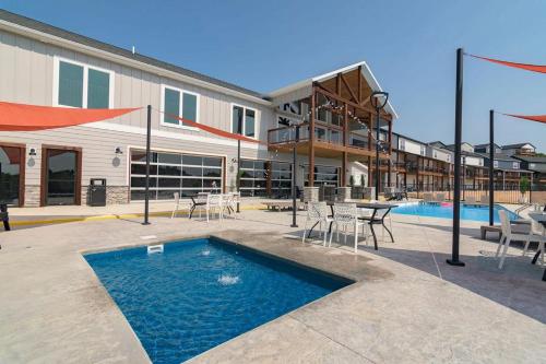 a swimming pool with a table and chairs next to a building at Idle Time at Table Rock Lake in Branson