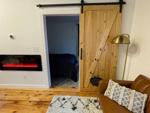 a living room with a couch and a fireplace at Double The Fun II Two Houses and fire pit in shared yard in Kingston