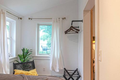 a bedroom with a bed and a window at Double The Fun II Two Houses and fire pit in shared yard in Kingston