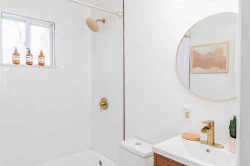 a white bathroom with a sink and a mirror at Double The Fun II Two Houses and fire pit in shared yard in Kingston