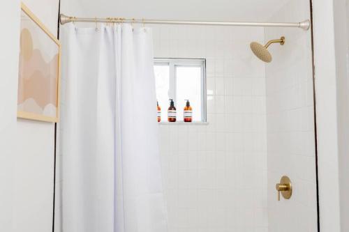 a shower with a white shower curtain in a bathroom at Double The Fun II Two Houses and fire pit in shared yard in Kingston