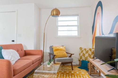 a living room with a couch and a table at Double The Fun II Two Houses and fire pit in shared yard in Kingston