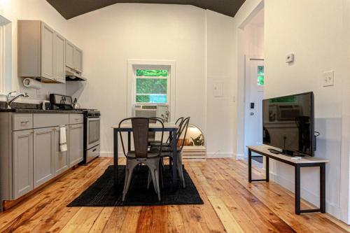 a kitchen with a table and chairs in a room at Double The Fun II Two Houses and fire pit in shared yard in Kingston