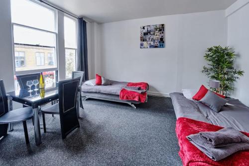 a living room with a couch and a table at Central flat in Basingstoke in Basingstoke