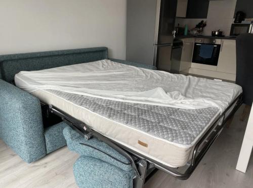 a bed sitting on a couch in a room at Appartement Stella-Plage in Cucq