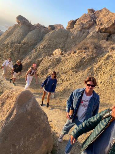 a group of people walking on a rocky trail at West coast surf house in Imsouane