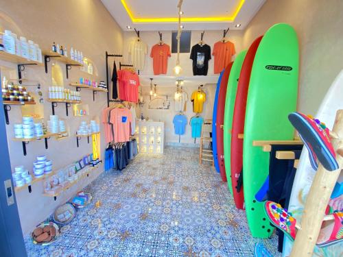 a room with a bunch of surfboards on a wall at West coast surf house in Imsouane