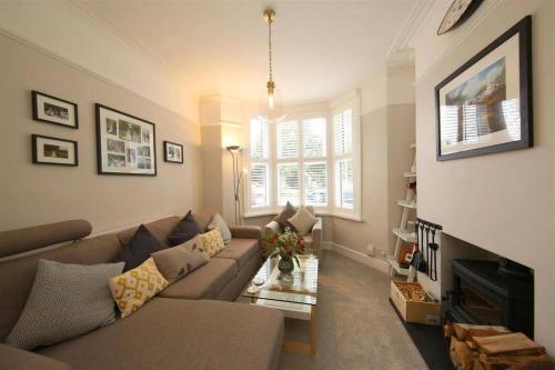 a living room with a couch and a fireplace at Perfectly Positioned Pad in Cardiff
